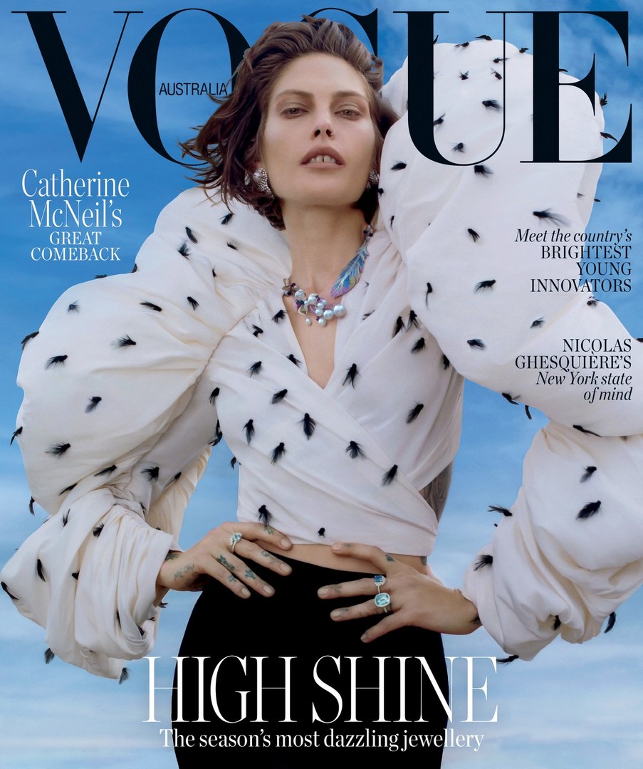 Vogue cover featuring a fashion model wearing jewelry and a white blouse with black details against a blue sky background.