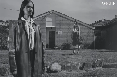 Black and white fashion editorial featuring two models in front of a suburban brick house styled by Petta Chua