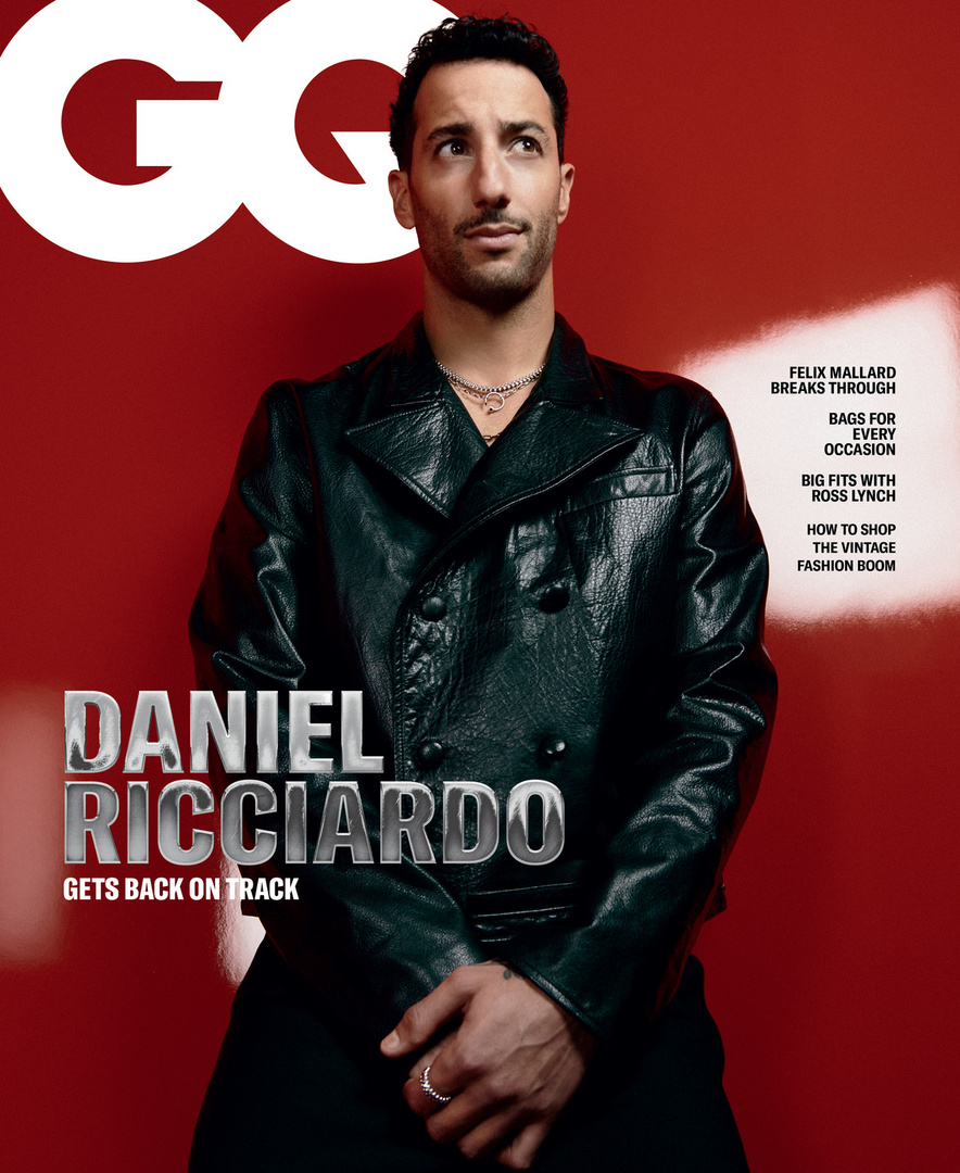 Daniel Ricciardo poses on the cover of GQ Magazine, wearing a black leather jacket against a red background with magazine text.