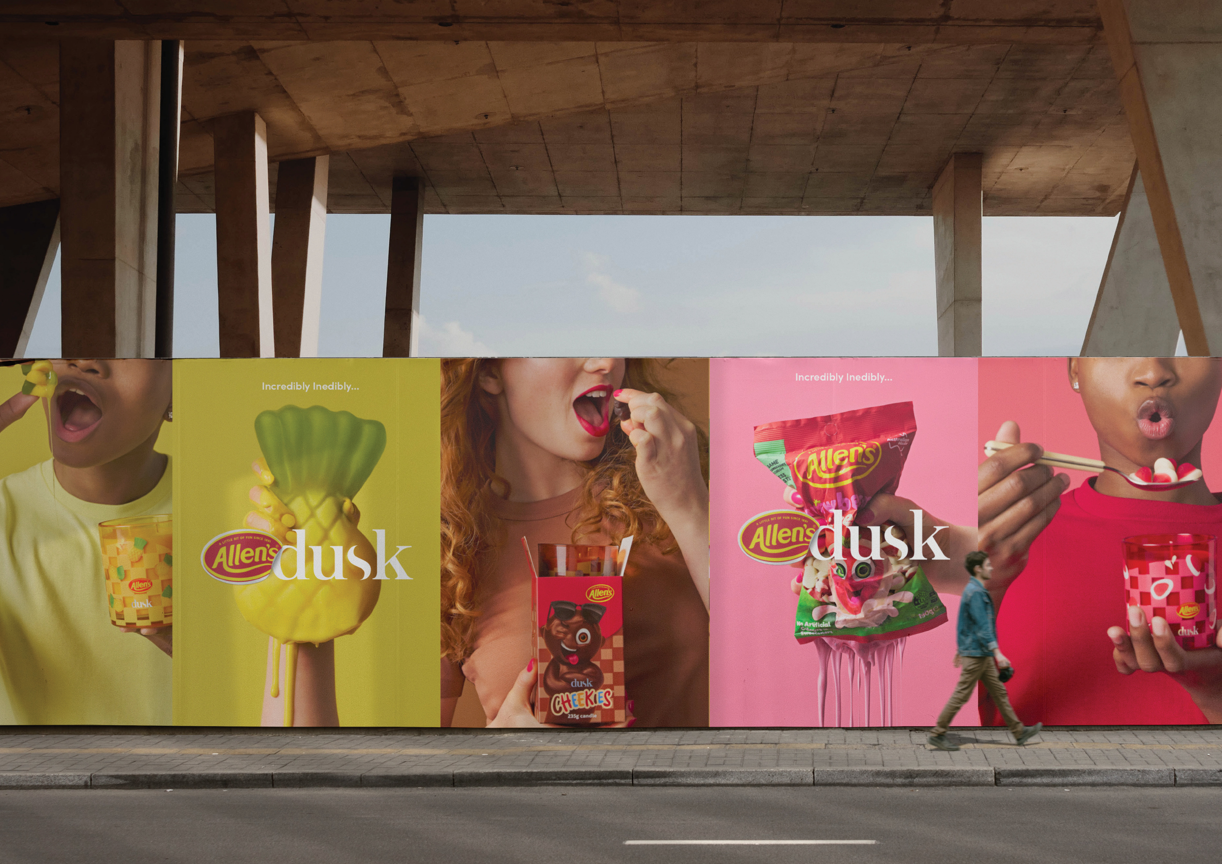 Outdoor advertising billboard featuring four diverse individuals enjoying Allen's dusk candy, with a man walking by the advertisement.
