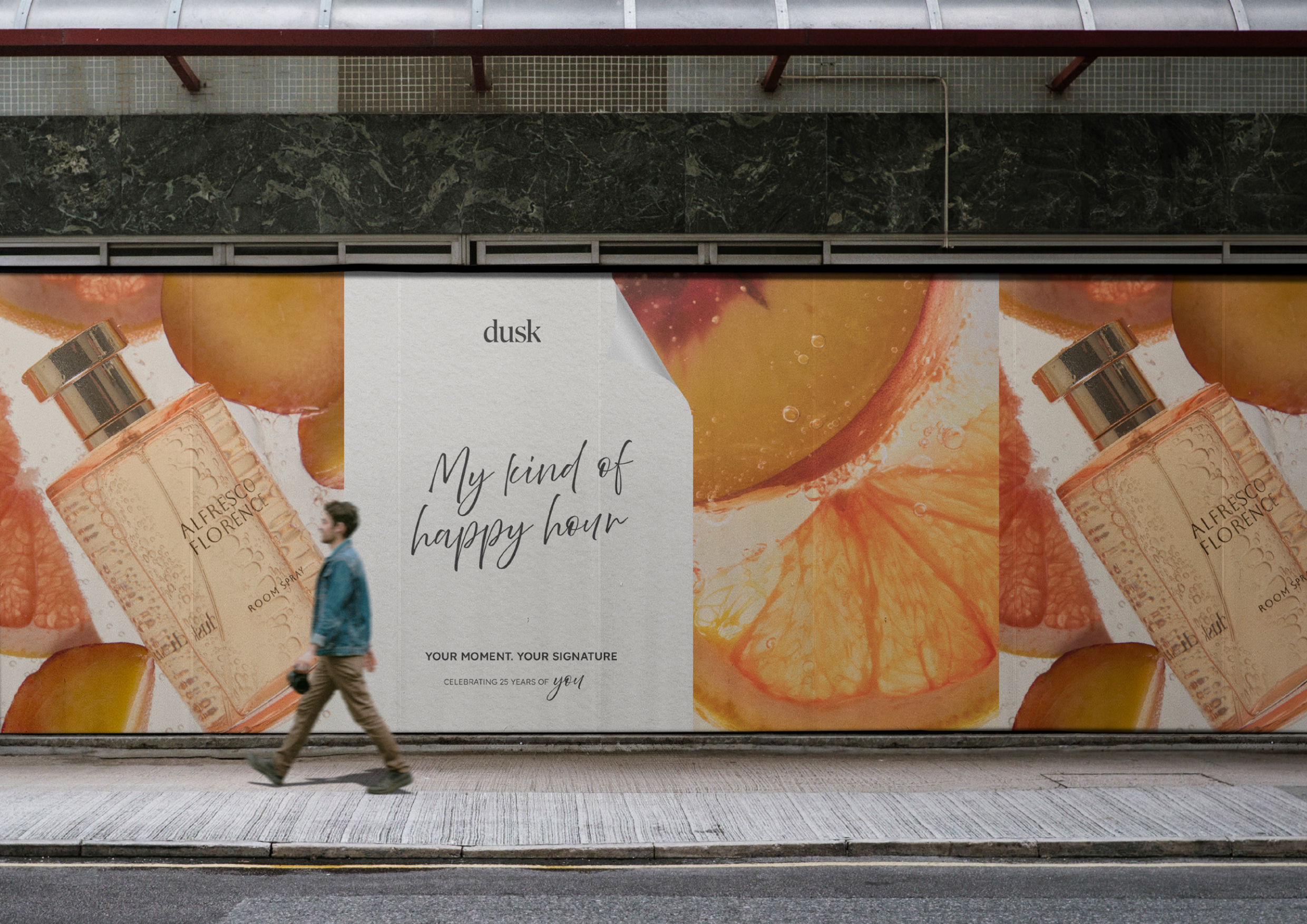 Perfume advertisement featuring a walking man and a large perfume bottle with citrus fruit on a city street, showcasing the product.