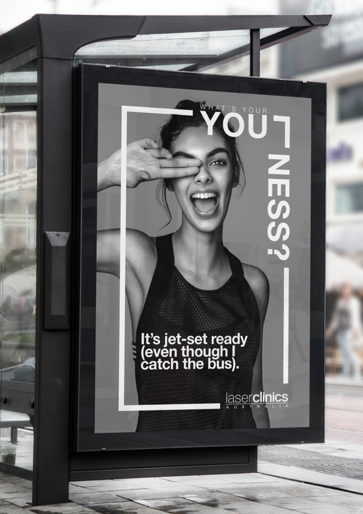 Laser Clinics Australia advertisement featuring a smiling woman covering one eye, displayed on a bus stop shelter in an urban setting.