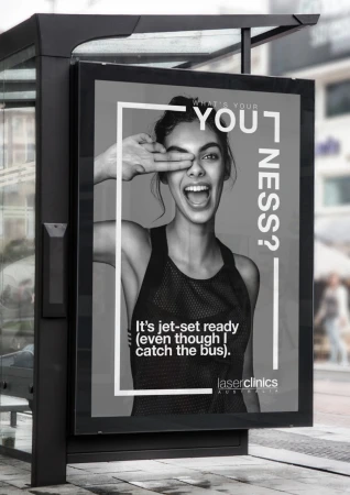 Laser Clinics Australia advertisement featuring a smiling woman covering one eye, displayed on a bus stop shelter in an urban setting.