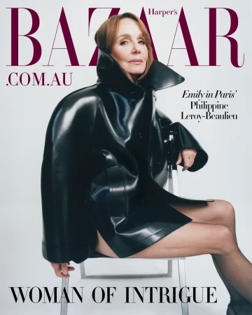 Philippe Leroy-Beaulieu, actress, is seen on the cover of Harper's Bazaar wearing a black patent leather jacket and sitting on a clear acrylic chair.