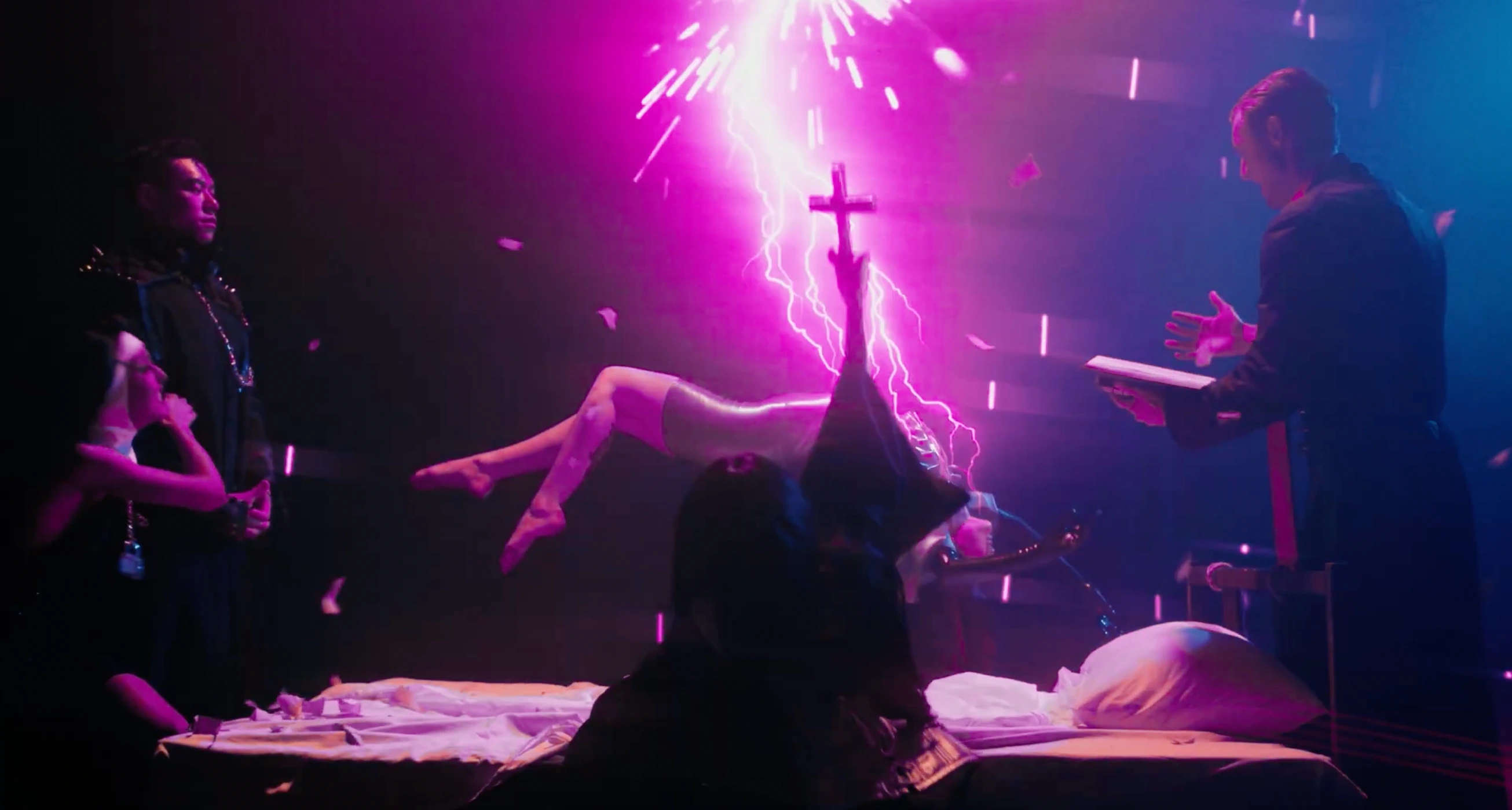 Cinematic scene featuring a person levitating above a bed while glowing pink lightning strikes in a dark room illuminated by neon lights.