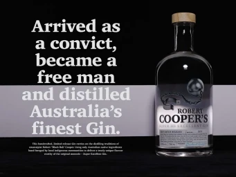 A glass gin bottle with a wooden stopper and ball and chain graphic against a dark background with white typography text
