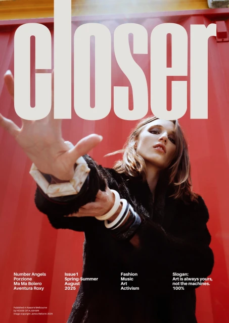 Magazine cover featuring a woman in a black jacket with white bracelets, posing against a red background with large white text overlay.