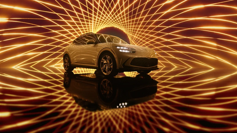 A white SUV-style car is presented with a dark background and reflective floor, with glowing orange lines around it.