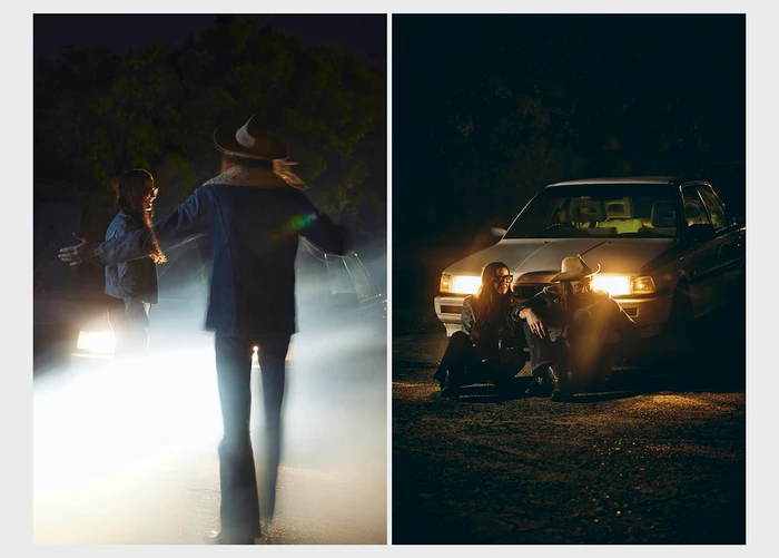 Two people posing in front of a parked car with headlights on during the night in Melbourne by Catherine Black
