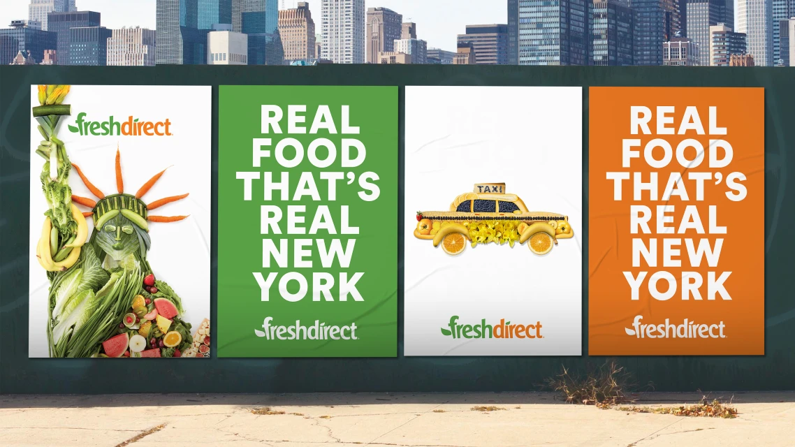 Fresh Direct posters showcase New York City landmarks made of produce: the Statue of Liberty and a yellow cab. Cityscape in the background.