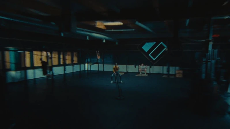 Several athletes engaging in various fitness activities inside a dimly lit gym, performing squats, chin ups, and battle rope exercises.