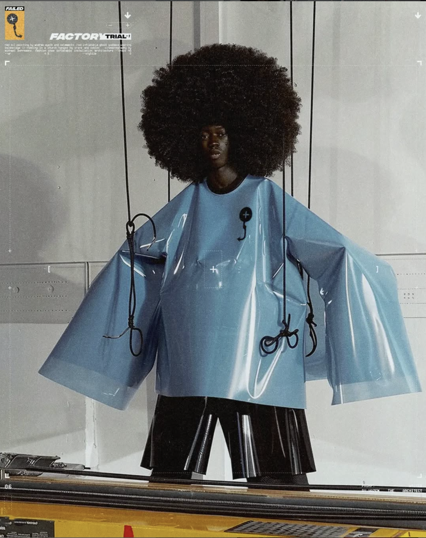 Fashion-forward portrait of a Black model with an afro, wearing a glossy blue oversized top and black shorts in a modern setting.
