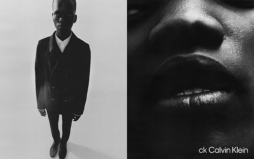 Monochrome portrait of a dark-skinned male model in a dark suit on a white background, plus a close-up of a face and the ck Calvin Klein logo.