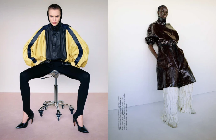 Two fashion models posing against a neutral studio background, styled by Adrien Pinault with striking garments.