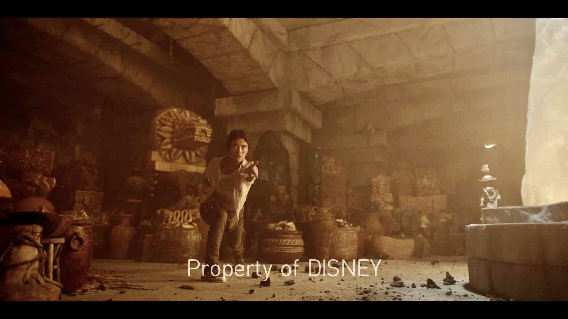 A scene captures an adult female in action within a dimly lit, ancient temple-like setting, surrounded by stone statues and artifacts.