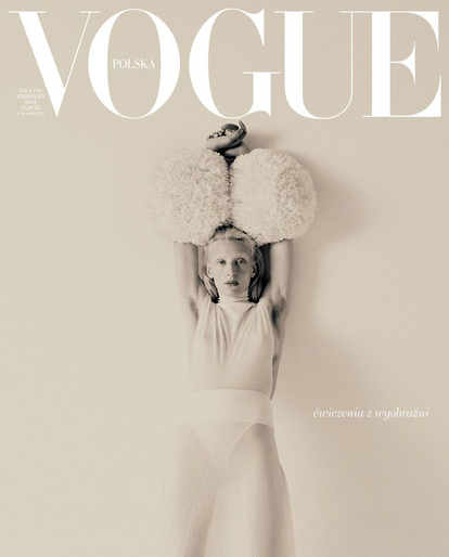 Vogue Polska cover featuring a pale-skinned person in a white outfit with a large fluffy hat against a light beige background.