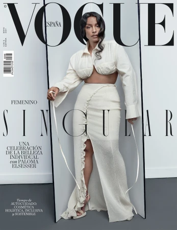 Vogue España cover featuring Paloma Elsesser in a white ensemble, posing against a grey backdrop, with the Vogue logo prominently displayed.