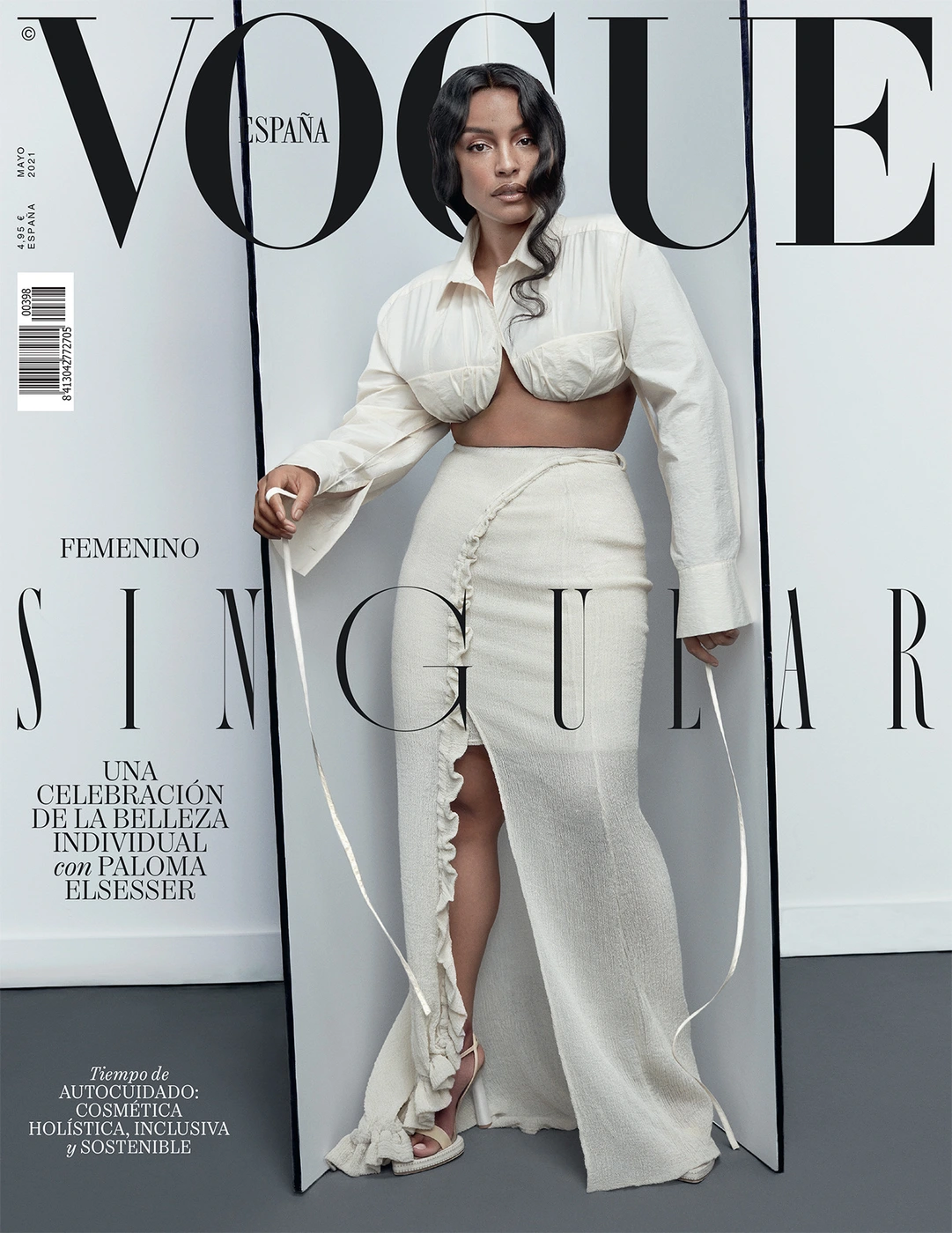 Model in cream two piece crop top and long skirt standing inside open folding screen by Alique Studio