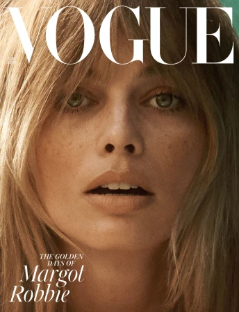 Close-up of a woman with shoulder-length blonde hair, light skin, and freckles on the cover of Vogue magazine featuring the title 'Vogue'.