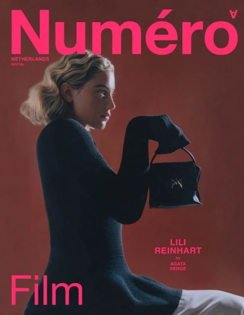 Magazine cover featuring Lili Reinhart in a side profile, wearing a black top and holding a black handbag against a muted red background.