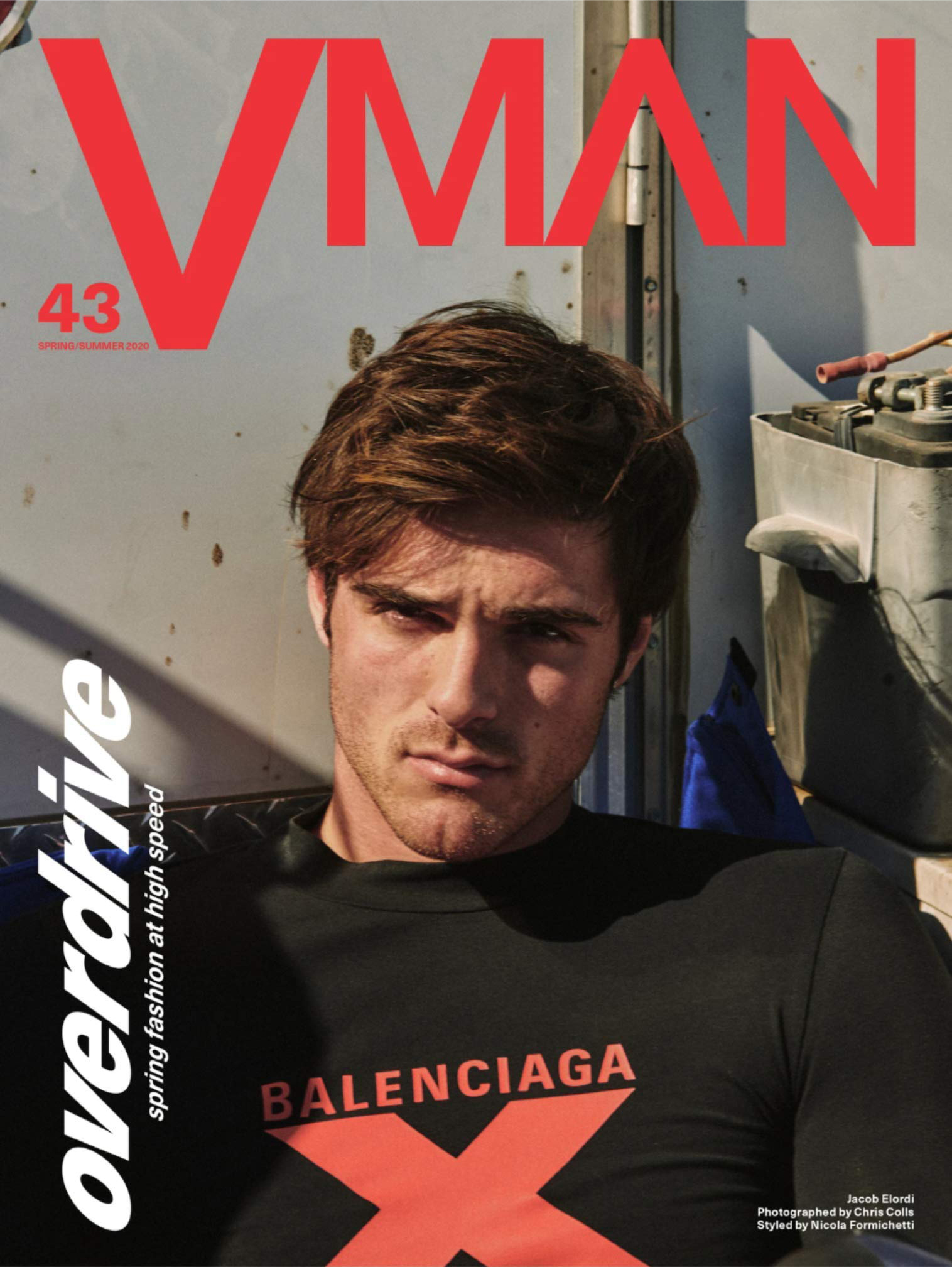 Magazine cover featuring a male model wearing a black Balenciaga long-sleeve shirt against a neutral, industrial background with visible text.