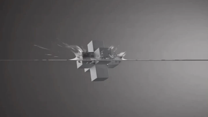 Abstract geometric cube shape partially submerged in water against a neutral grey backdrop, showcasing a visually striking scene.