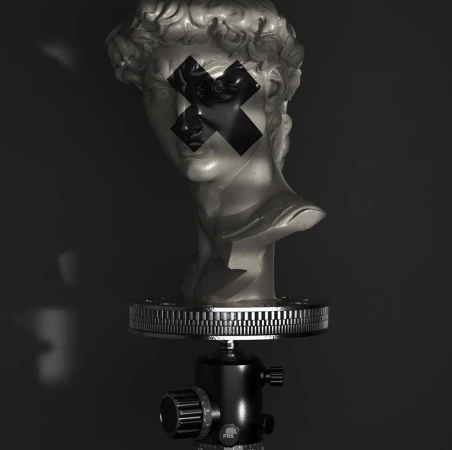 Bust sculpture on a tripod with black tape 'X' across the eyes, shot in a low-key style against a dark backdrop with faint lighting.