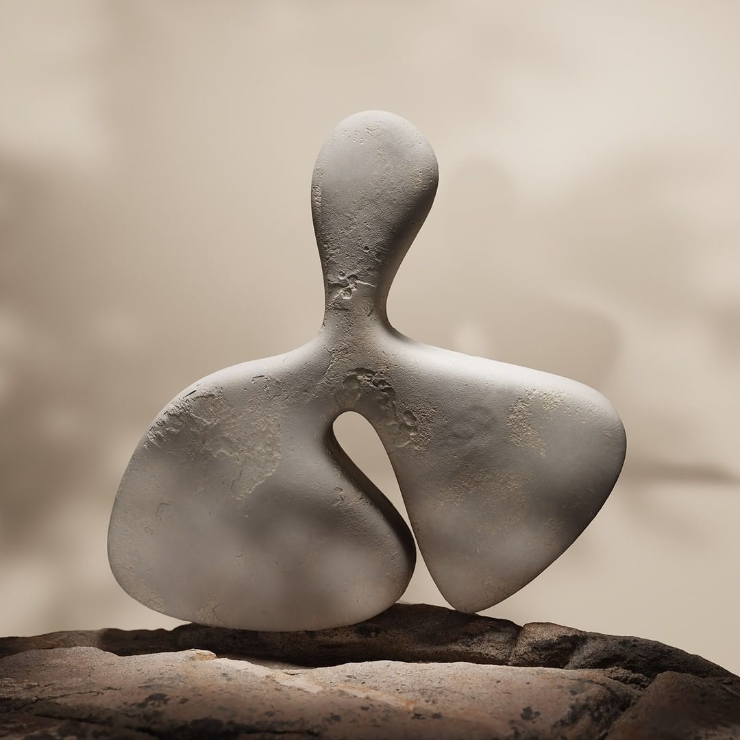 Abstract, organic-shaped sculpture sits atop a textured rock, set against a tan, cloudy background. The smooth, minimalist form evokes nature.