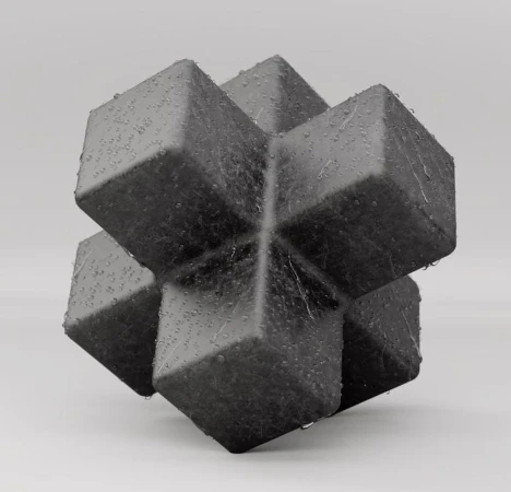 Close-up studio shot of a geometric cube-shaped object made of dark gray material with water droplets on a light gray background.