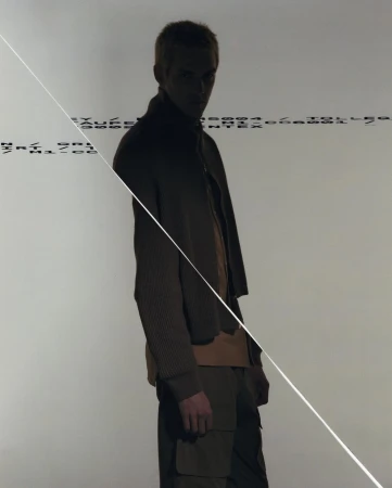 Man standing in shadow against a light background with overlaid text lines