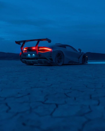 Sleek silver sportscar with a rear spoiler parked on a cracked dry lakebed under a dusk sky, taillights glowing red, artistic render.