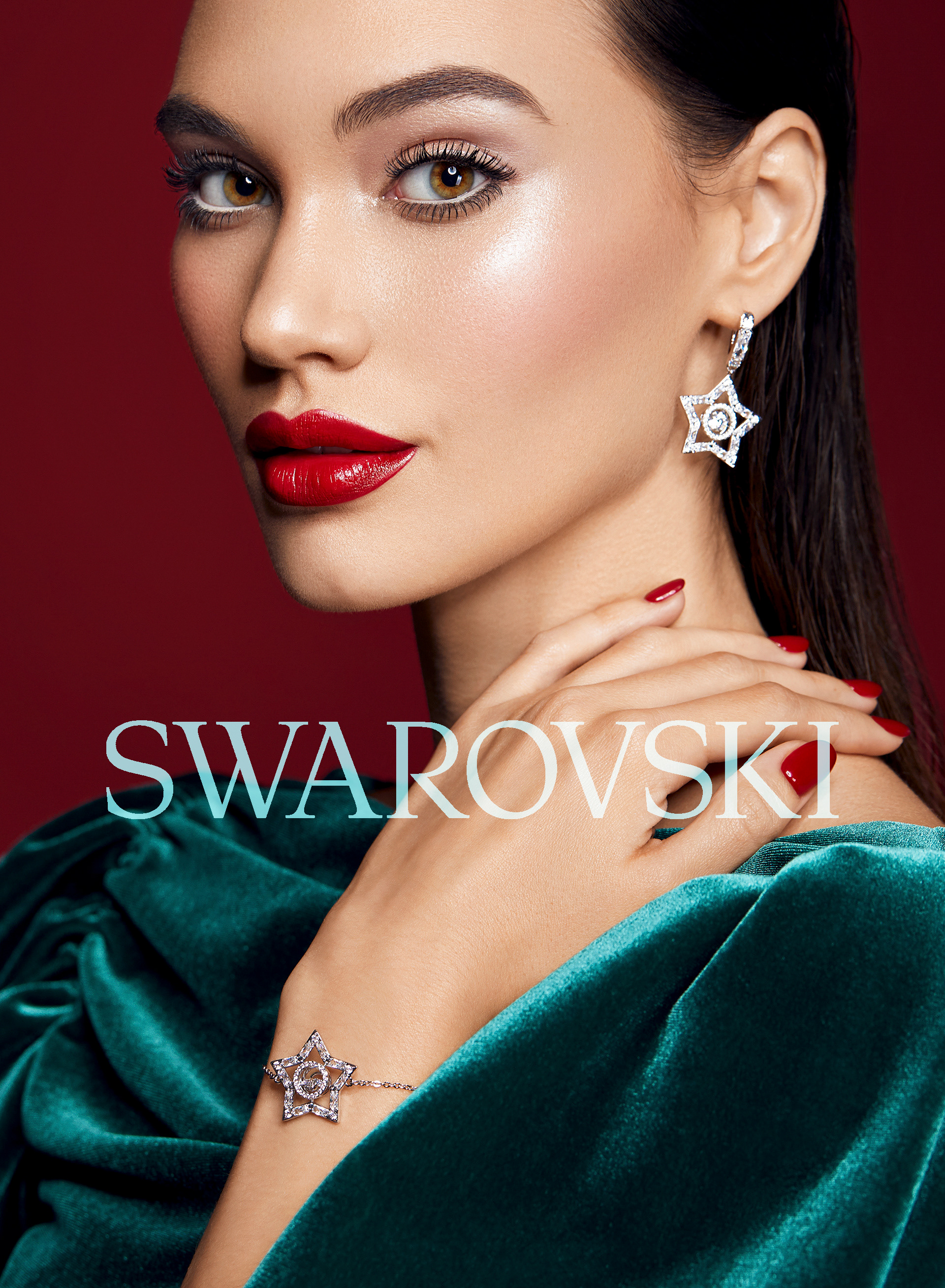 Close-up of a woman showcasing star-shaped diamond jewelry: earrings and a bracelet, against a red backdrop with text overlay.