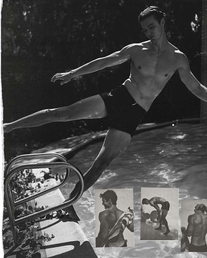 Athletic man in mid-air leaps into a pool, ladder in view, set against lush greenery in vintage black and white style.