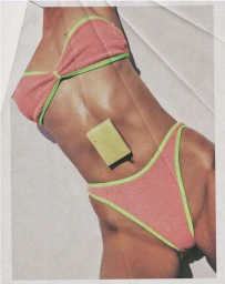 Close-up of a person wearing a pink textured bikini with lime green trim and a bar of soap resting on their abdomen.