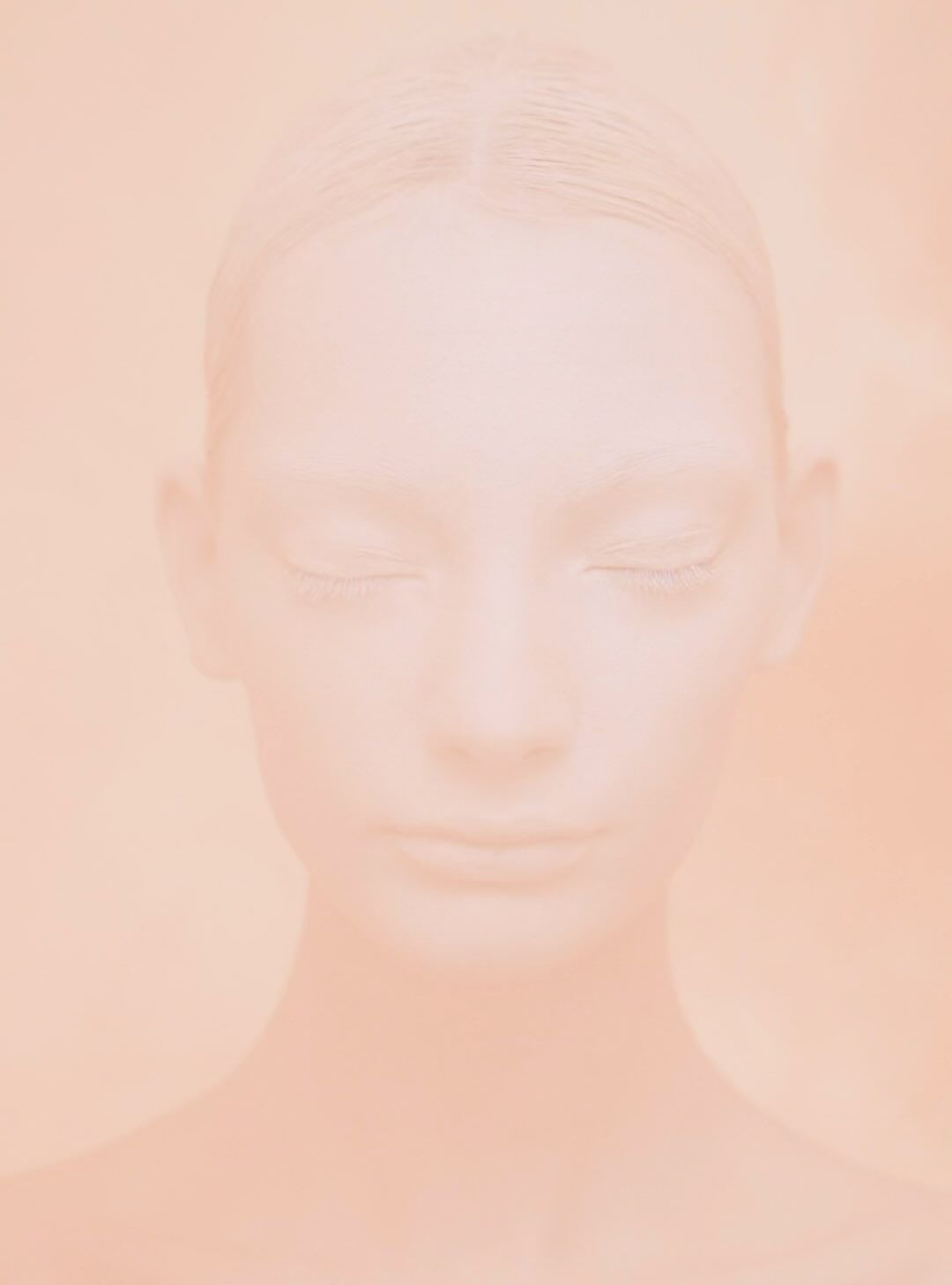Close-up portrait of a light-skinned woman with closed eyes and pale complexion, immersed in a monochromatic peach-toned ethereal ambiance.