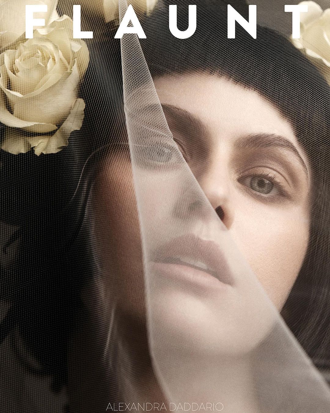 Close-up fashion-style portrait of Alexandra Daddario with a veil and white roses framing her face. Magazine cover aesthetic and soft lighting.