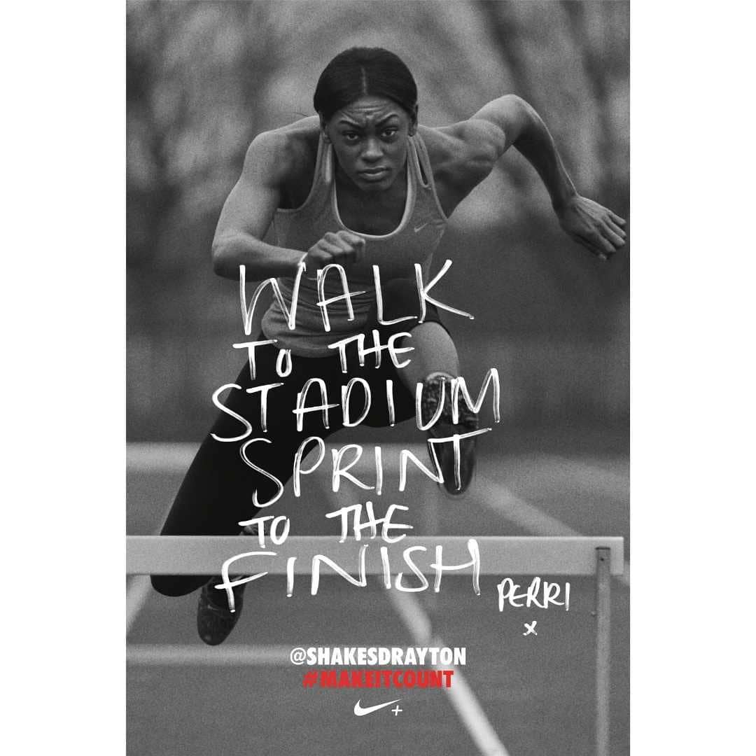 Black and white image of a female athlete leaping over a hurdle on a track, showcasing her strength and agility in sports photography.