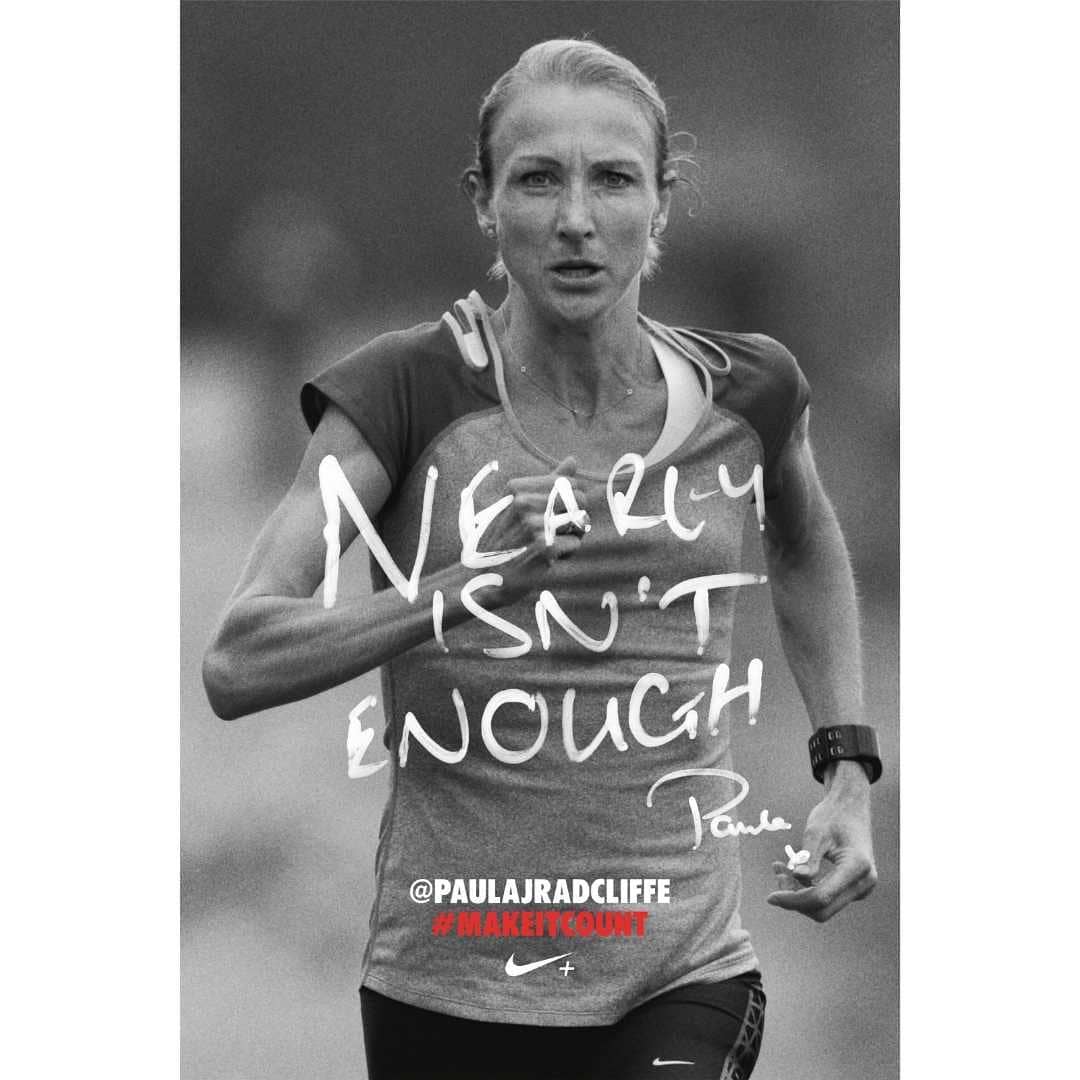 Black and white portrait of Paula Radcliffe running, wearing a two-tone tee shirt, wrist device, superimposed text, and Nike branding.