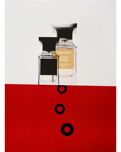 Tom Ford White Suede perfume bottles on a two-tone white and red background with geometric black accents in a studio setting.