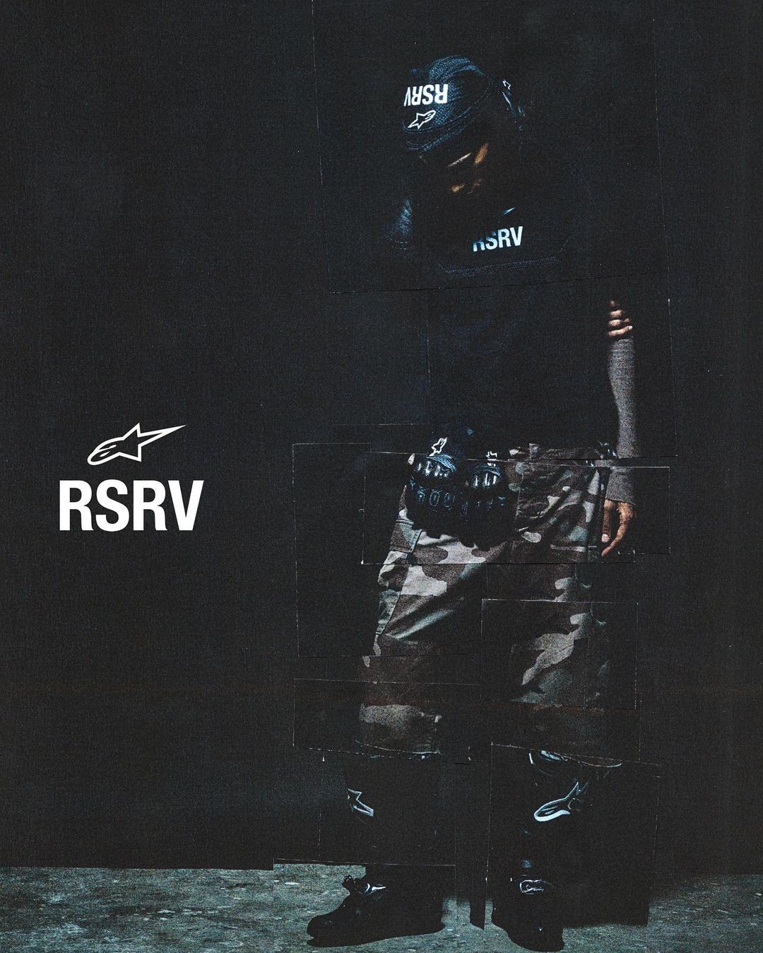 Man wearing camouflage pants and black RSRV apparel poses against a dark backdrop in a studio shot with visible stitching details.