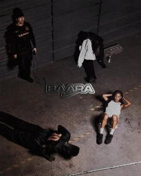 High-angle view of four people posing in a gritty industrial space with dark clothing, a white towel, and a centered metallic brand logo