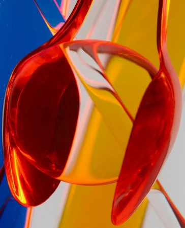 Abstract art featuring curved red and yellow acrylic shapes against a blue background, creating a visually dynamic composition.