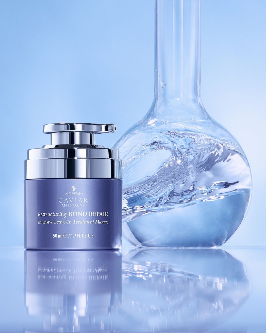 Alterna Caviar anti-aging bond repair masque with a Erlenmeyer flask filled with swirling water, studio shot on light blue.