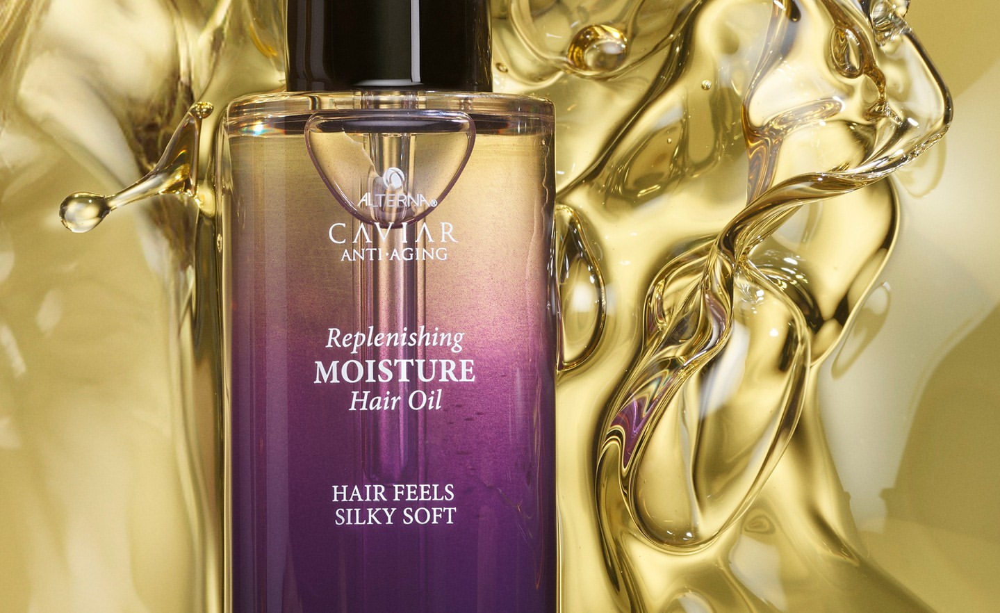 Alterna Caviar Anti-Aging Replenishing Moisture Hair Oil bottle on a gold background with gold liquid swirling around it.