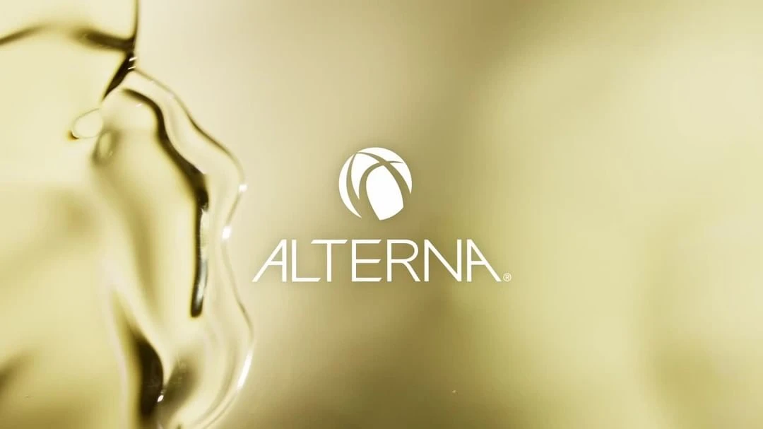 Alterna brand logo displayed with liquid, highlighting the beauty and hair care industry aesthetic and product quality.