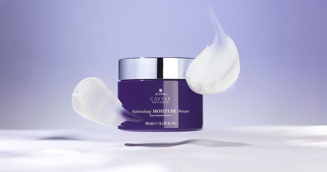 Purple Caviar Anti-Aging Replenishing Moisture Masque jar with silver lid and white cream swirls on a light purple background.