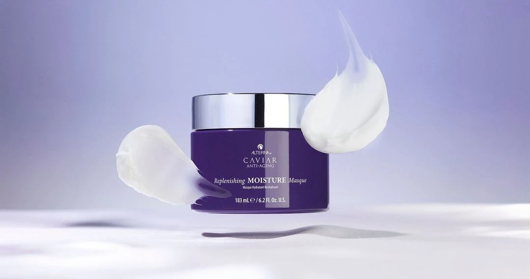 Purple Caviar Anti-Aging Replenishing Moisture Masque jar with silver lid and white cream swirls on a light purple background.