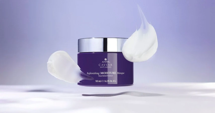 Purple Caviar Anti-Aging Replenishing Moisture Masque jar with silver lid and white cream swirls on a light purple background.