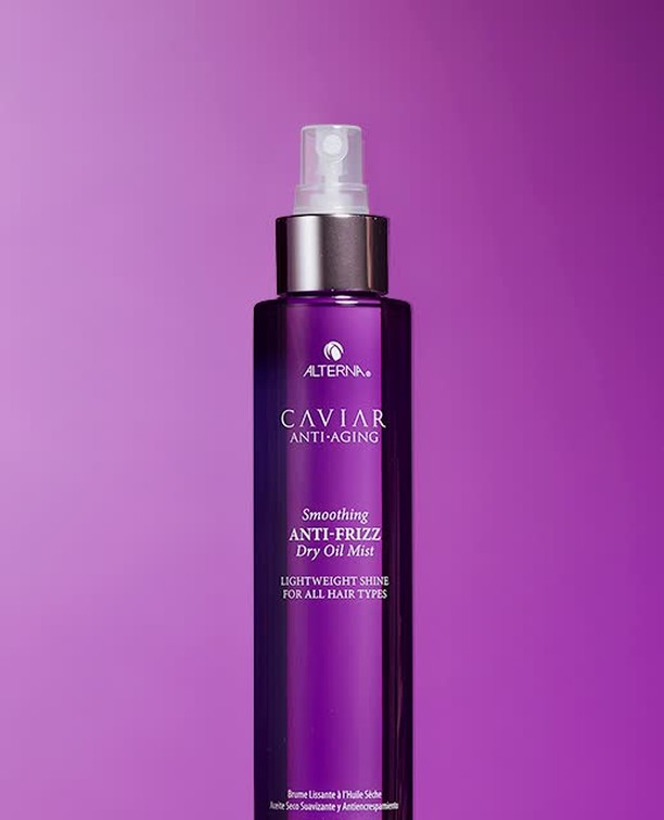 Alterna Caviar Anti-Aging Smoothing Anti-Frizz Dry Oil Mist. Purple bottle with silver accents set against a purple background.