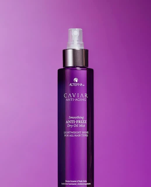 Alterna Caviar Anti-Aging Smoothing Anti-Frizz Dry Oil Mist. Purple bottle with silver accents set against a purple background.